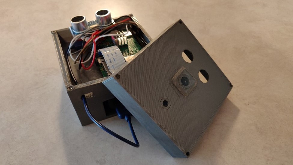 gray open box with mess of wires and electronics inside