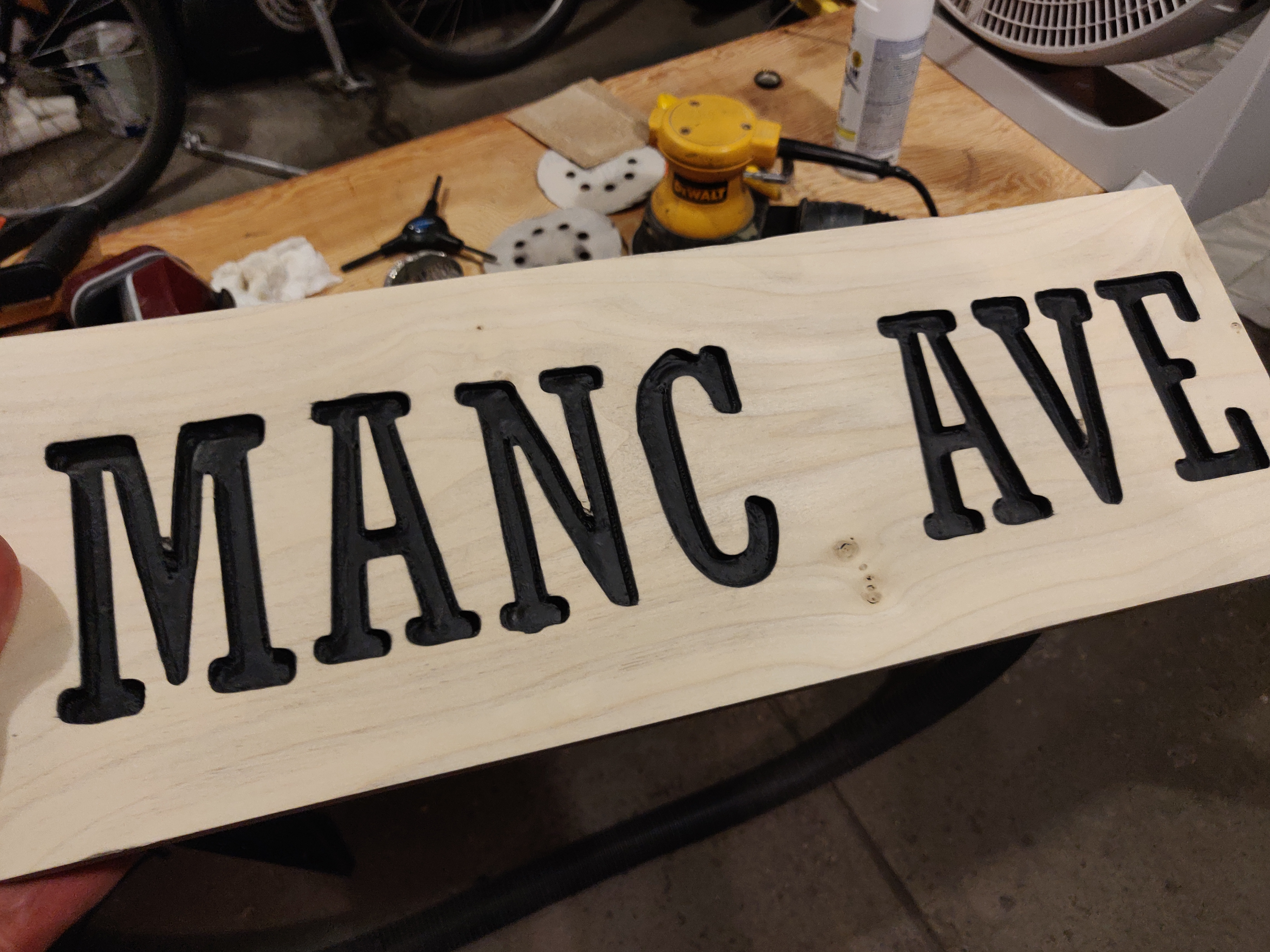 manc ave sign with letters painted black